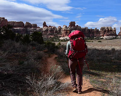 Backpacker hiking in the Needles district of Canyonlands National Park