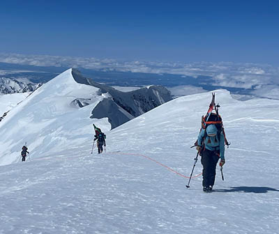 Climbers traveling through snow in Ruth Gorge, Denali National Park